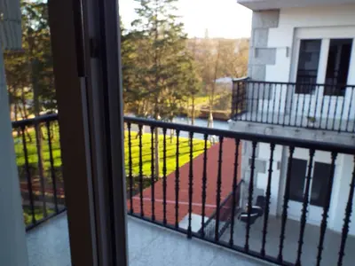 a balcony with a view of a yard at Hotel Ansuiña in Baños de Molgas