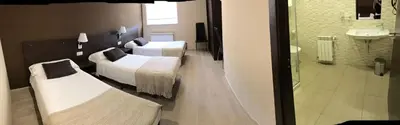 a hotel room with two beds and a window at Pensión Lemos in Tríacastela
