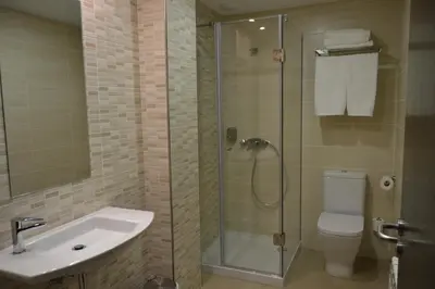 a closet in a room with a table and a tv at Pensión Lemos in Tríacastela