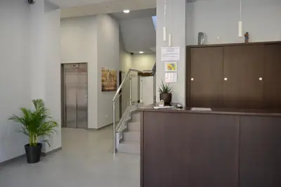 a lobby with a staircase and a reception desk at Pensión Lemos in Tríacastela