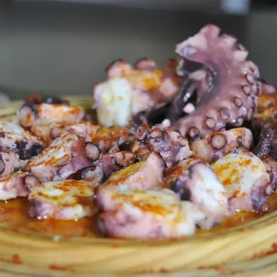 a plate of food with meat and mushrooms on it at Pons Minea in Portomarin