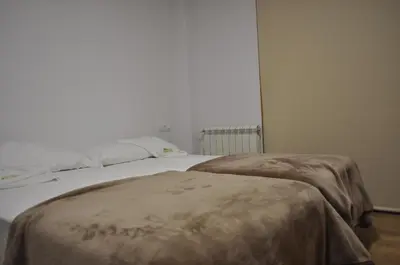 a bedroom with a bed with a blanket on it at Pons Minea in Portomarin