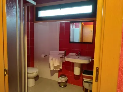 a bathroom with a toilet and a sink at Via Stellae in Tamallancos