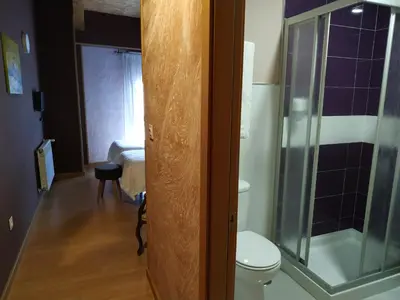 a bathroom with a toilet and a glass shower at Via Stellae in Tamallancos