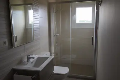 a bathroom with a shower and a toilet and a sink at Viviendas Uso Turístico Arzúa in Arzúa