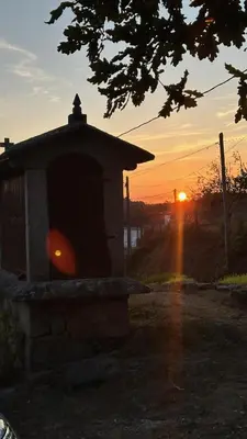 a bird house with a sunset in the background at Casa Rural A Cobacha in Paderne