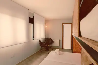 a room with a bed and a chair in it at Hotel La Casa Del Abuelo in Tapia de Casariego