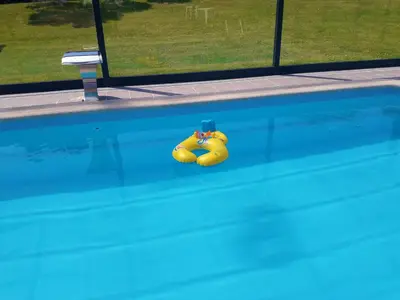 a yellow rubber ducky laying on the side of a swimming pool at Hotel La Casa Del Abuelo in Tapia de Casariego