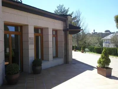 a building with potted plants in front of it at Parador de Puebla de Sanabria in Puebla de Sanabria