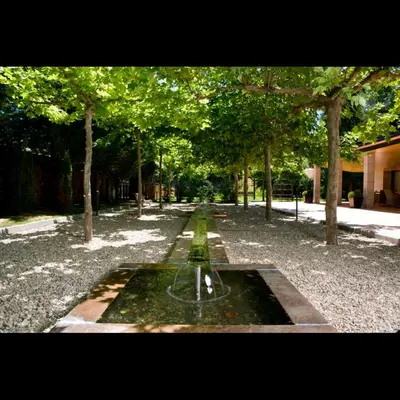 a fountain in the middle of a park with trees at Parador de Puebla de Sanabria in Puebla de Sanabria