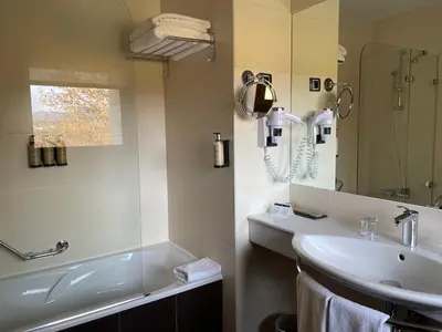 a bathroom with a sink and a mirror at Parador de Puebla de Sanabria in Puebla de Sanabria