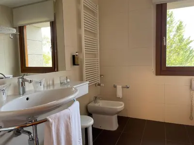 a bathroom with a sink and a toilet at Parador de Puebla de Sanabria in Puebla de Sanabria