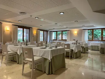 a dining room with white tables and chairs at Parador de Puebla de Sanabria in Puebla de Sanabria