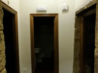 a door leading to a bathroom with a toilet at Casa de los Somoza in Melide