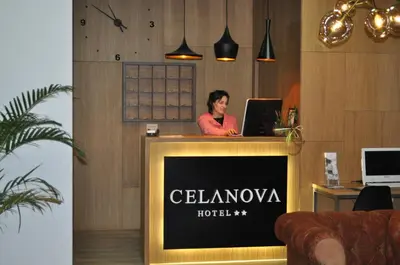 a woman standing at a counter with a laptop at Hotel Celanova in Celanova