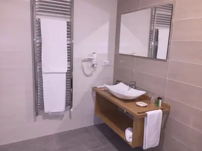 a bathroom with a sink and a mirror at Hotel Celanova in Celanova