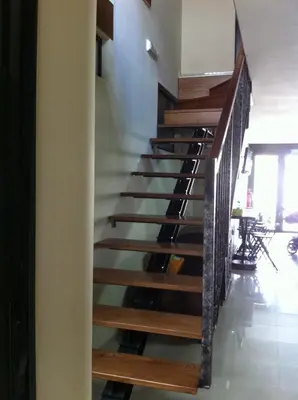a staircase in a building with wooden rails at Pension Siete en el Camino in Sarria