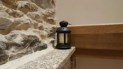 a black candle sitting on a stone wall at Pension Albergue Alborada in Salceda