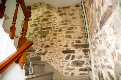 a stone staircase with a stone wall at Xavestre Rooms Santiago in Santiago de Compostela