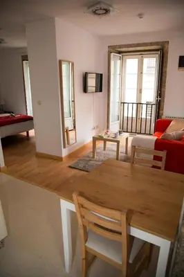a living room with a table and a couch at Xavestre Rooms Santiago in Santiago de Compostela