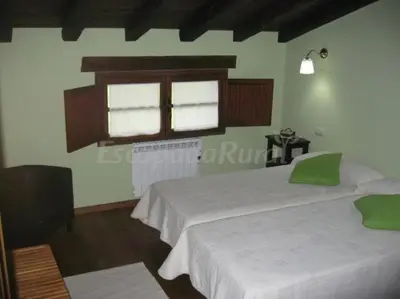 a bedroom with two beds and a window at Casa Carballeira in Villarfernando