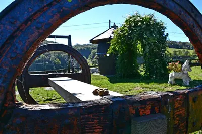 an old chest with a bench and a dog in a field at Apartamentos Rurales RON in Ron