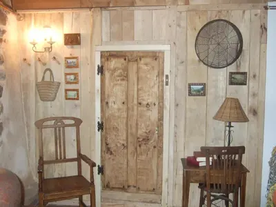 a room with a wooden wall with a door at Laventanadetorre in Torre de Babia