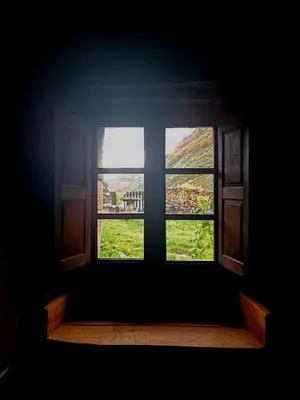 an open window with a view of a green field at Laventanadetorre in Torre de Babia