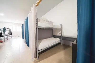 a group of bunk beds in a room at Albergue Barullo - Cubículos - Literas - Habitaciones in Sarria