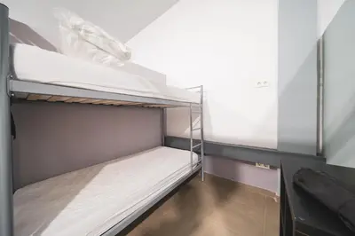 a small room with a bunk bed in it at Albergue Barullo - Cubículos - Literas - Habitaciones in Sarria