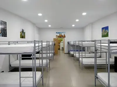 a row of bunk beds in a room at Albergue Barullo - Cubículos - Literas - Habitaciones in Sarria