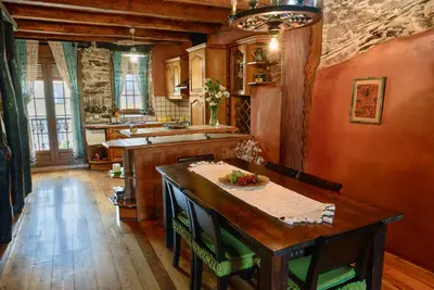 a kitchen with a wooden table in a room at Casa do Eiró in Lago de Carucedo