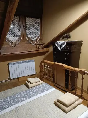 a bedroom with a bed with two towels on it at Casa do Eiró in Lago de Carucedo