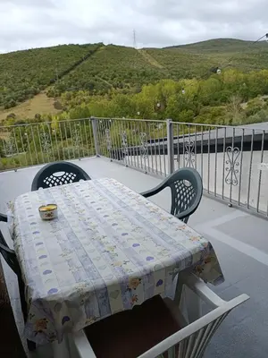 a table and chairs sitting on a balcony with a view at Casa do Eiró in Lago de Carucedo