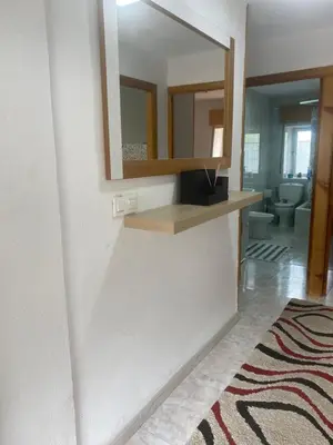 a bathroom with a mirror and a sink and a toilet at Casa Rural La Corrada in Llamoso