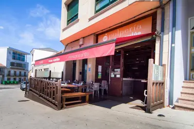 a restaurant with a table outside of a building at Pension Restaurante Casa Camiño in Palas de Rei