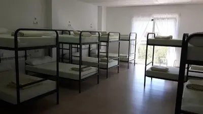 a group of bunk beds in a room at Albergue O Trisquel in O Pedrouzo