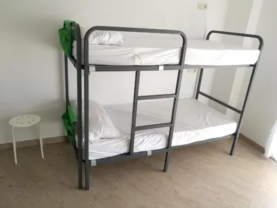 a couple of bunk beds in a room at Albergue O Trisquel in O Pedrouzo