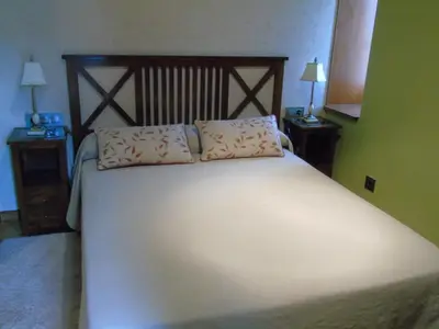 a bedroom with a large bed with two pillows on it at Casa da Paioca in Paleo