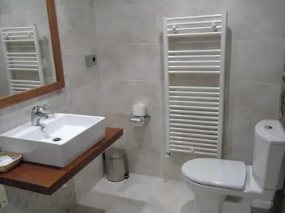 a bathroom with a sink and a toilet and a mirror at Casa da Paioca in Paleo