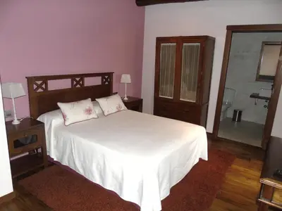 a bedroom with a large white bed with a mirror at Casa da Paioca in Paleo