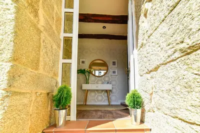 a hallway with two potted plants on a table at Casa da Xeitosa in Barbudo