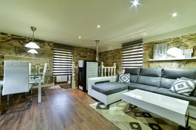 a living room with a couch and a table at Casa da Xeitosa in Barbudo