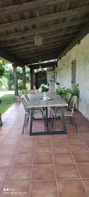 a table and chairs sitting on a patio at Casa da Xeitosa in Barbudo