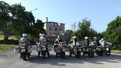 a group of people riding motorcycles on a road at Las Horas Perdidas in Moscán