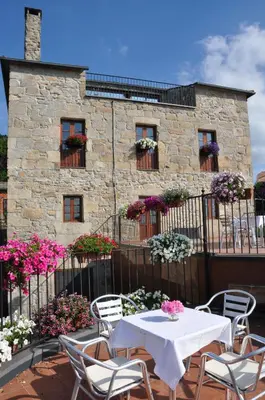 a table and chairs in front of a building at Las Horas Perdidas in Moscán