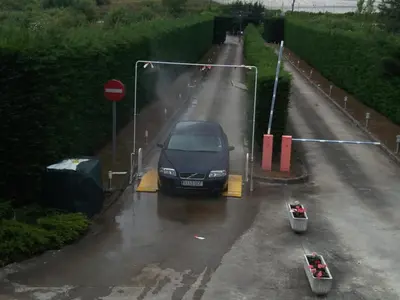 a black car parked on a road in the rain at Motel Acropolis in Camponaraya