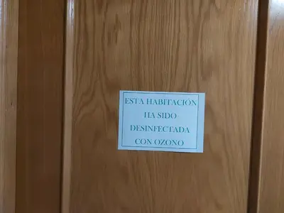 a sign on a door with a sign on it at Motel Acropolis in Camponaraya