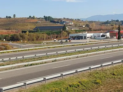 an empty highway with a truck on the road at Motel Acropolis in Camponaraya