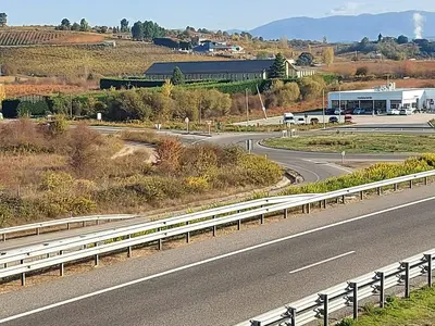 an empty highway with a bus on the road at Motel Acropolis in Camponaraya
